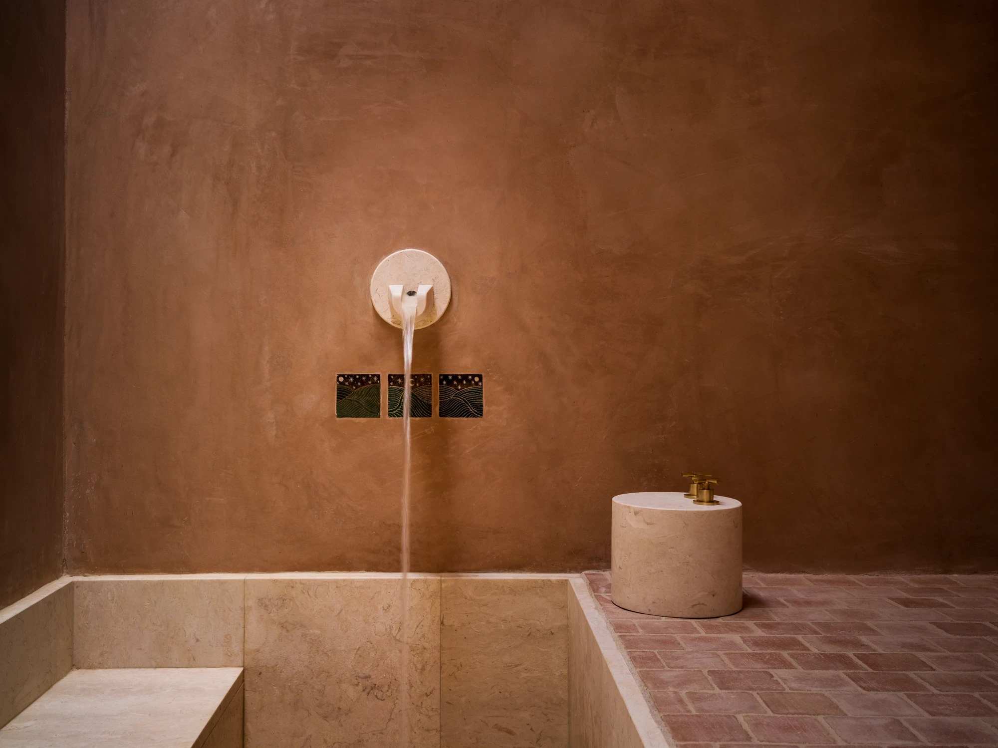 Hammam with mineral water spout and stone basin