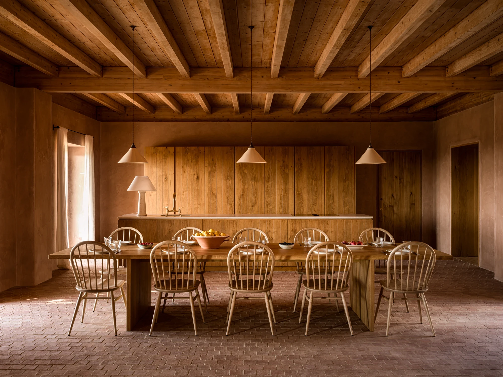 Long communal table beneath wooden beams