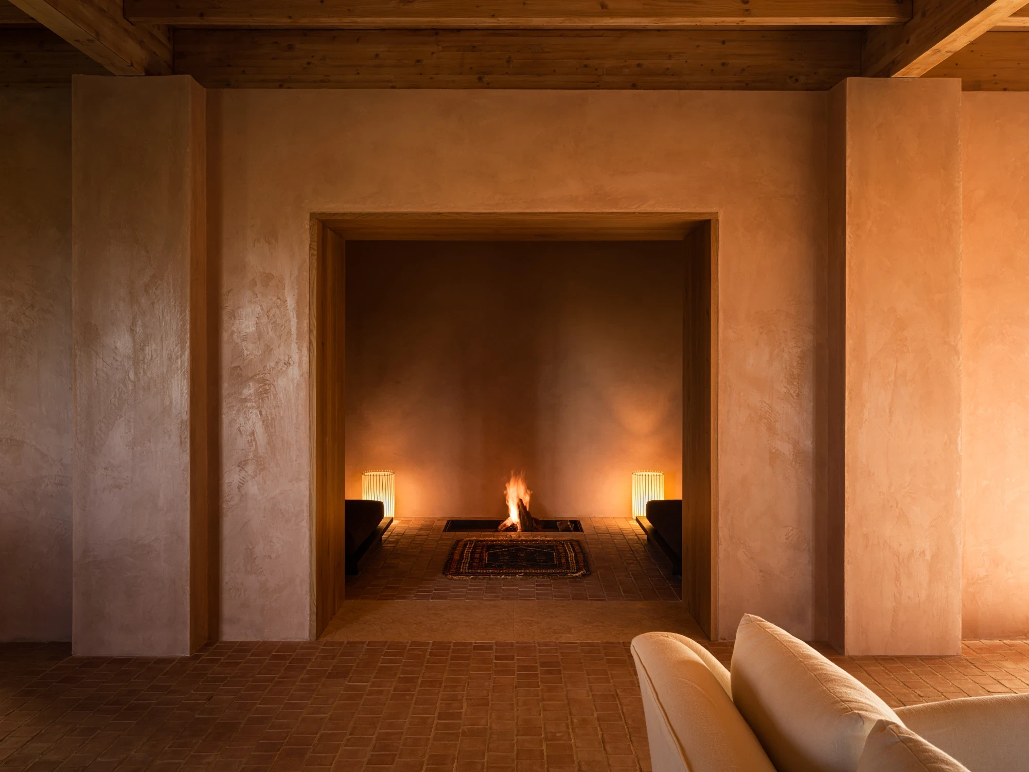 Fire in the hearth seen through an arched doorway