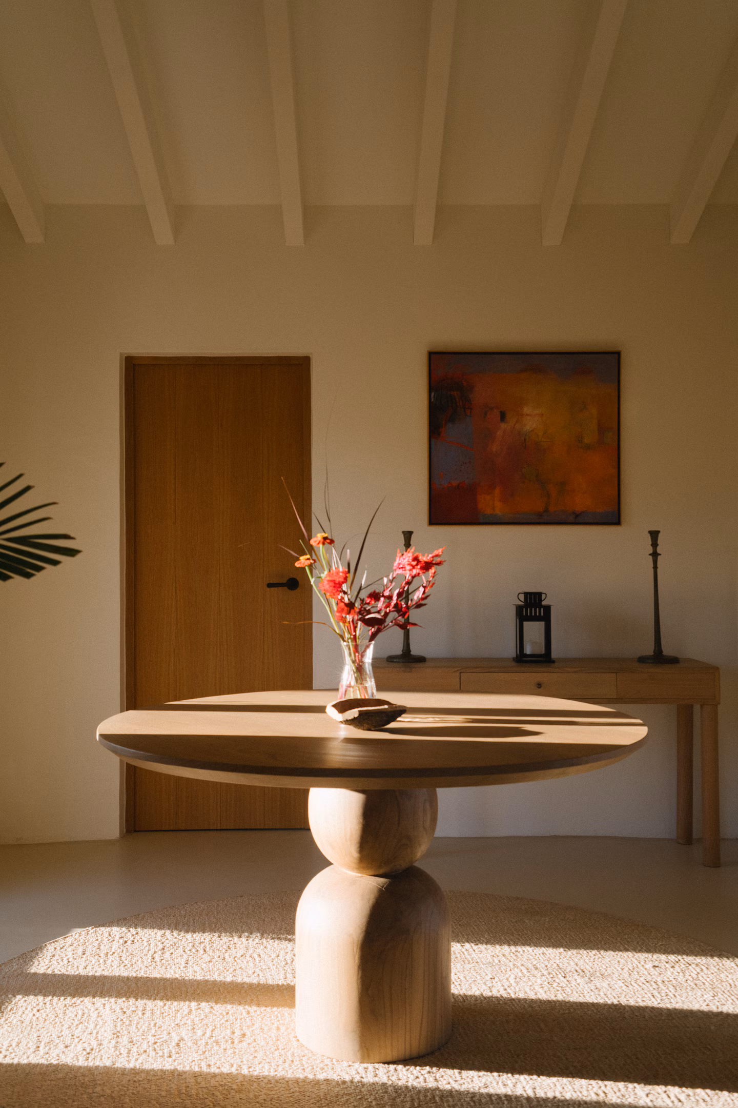 Entry with sculptural table and abstract painting